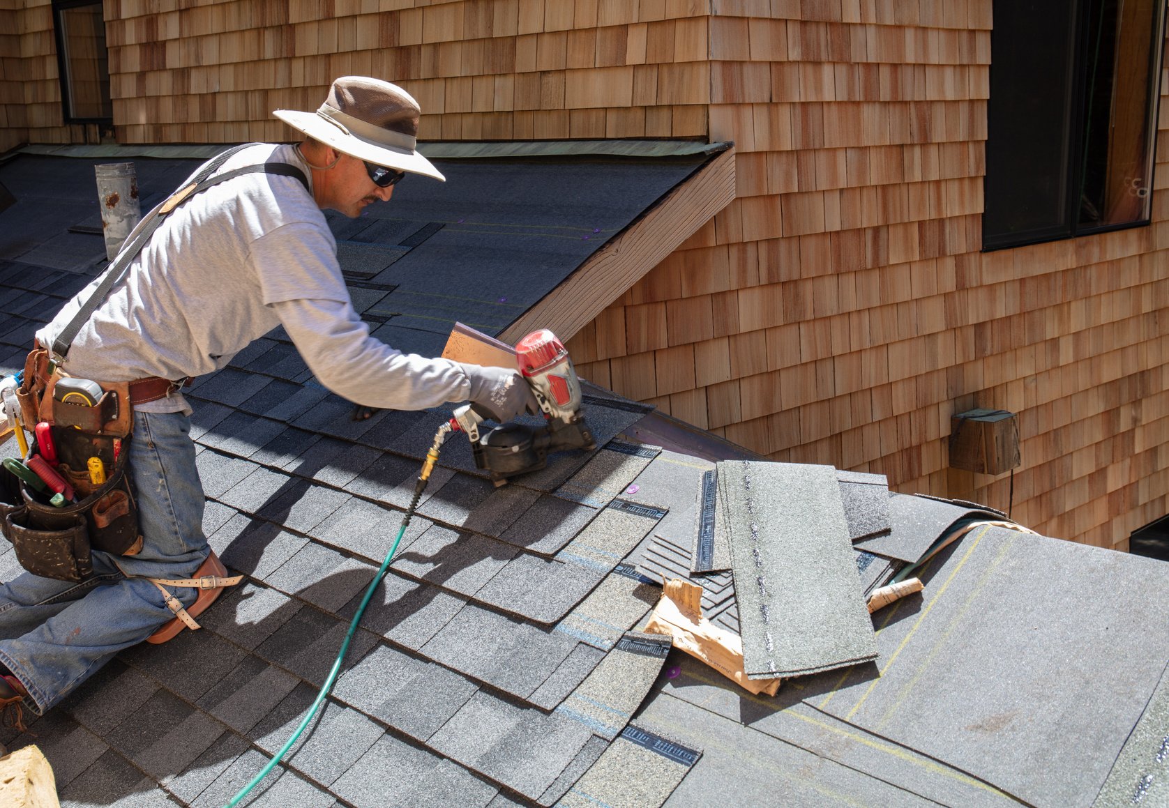 Man installing asphalt roof